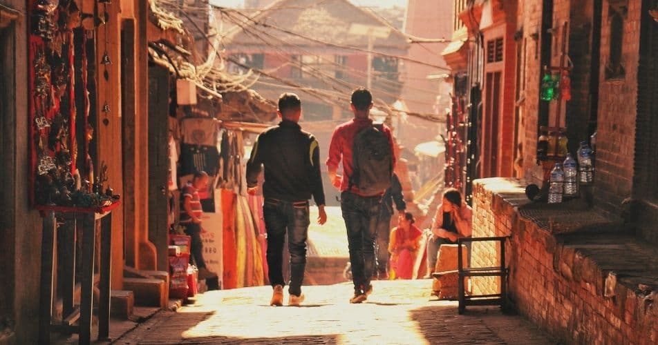 Two people walking in a Nepalese street