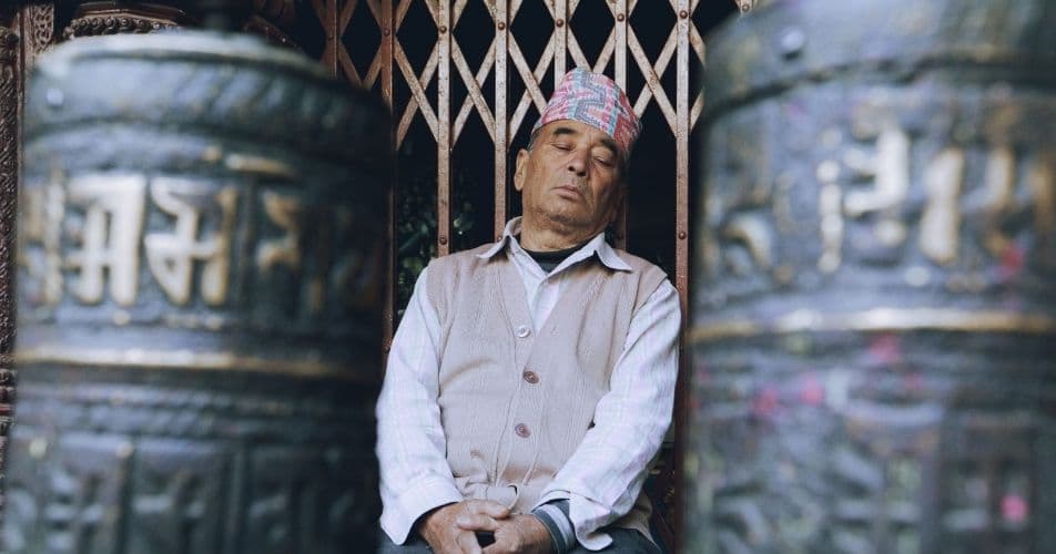 Time works differently in Nepal, a man sleeping in a Nepali street
