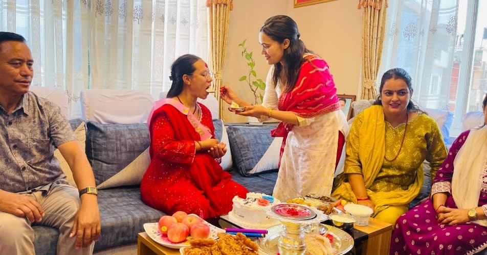 Hierarchy and respect during a Nepalese festival, young people giving tika to their elders
