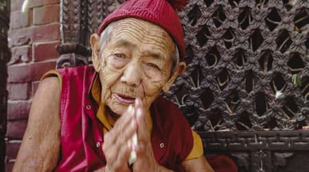 Nepalese monk doing namaste as sign of hospitality in Nepal